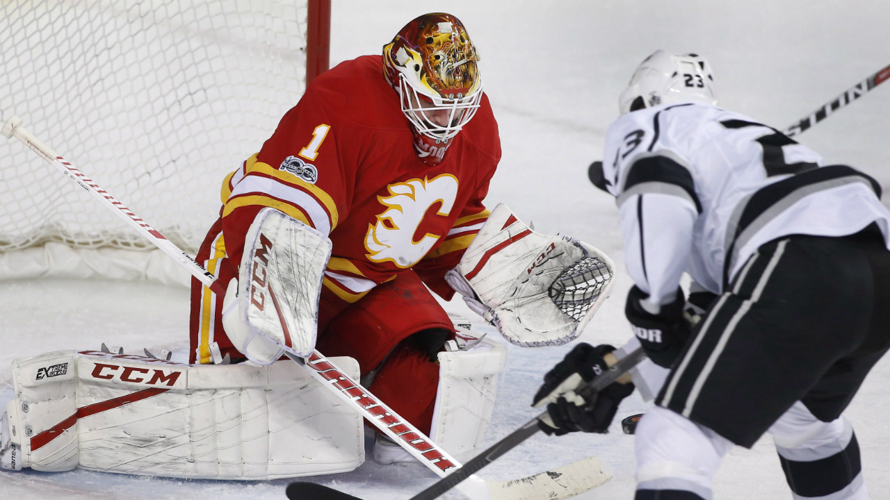 Calgary-Flames-goalie-Brian-Elliott,-left,-makes-a-save-against-Los-Angeles-Kings'-Dustin-Brown-during-second-period-NHL-action-in-Calgary,-Alta.,-Sunday,-March-19,-2017.-(Larry-MacDougal/CP)