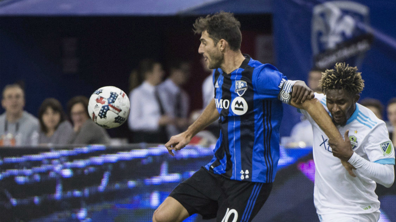 Montreal-Impact's-Ignacio-Piatti,-left,-holds-off-a-challenge-from-Seattle-Sounders-FC's-Oniel-Fisher-during-first-half-MLS-soccer-action-in-Montreal,-Saturday,-March-11,-2017.-(Graham-Hughes/CP)