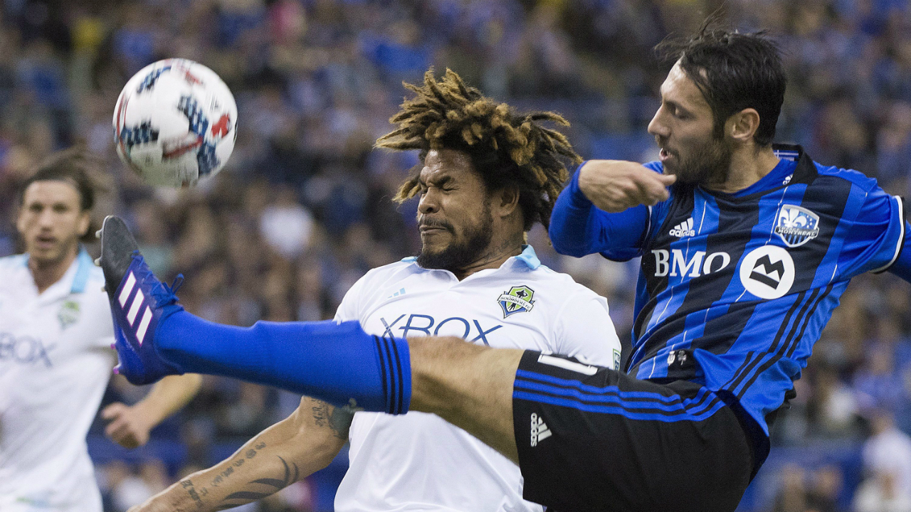 Montreal-Impact's-Matteo-Mancosu,-right,-challenges-Seattle-Sounders-FC's-Roman-Torres-during-first-half-MLS-soccer-action-in-Montreal,-Saturday,-March-11,-2017.-(Graham-Hughes/CP)