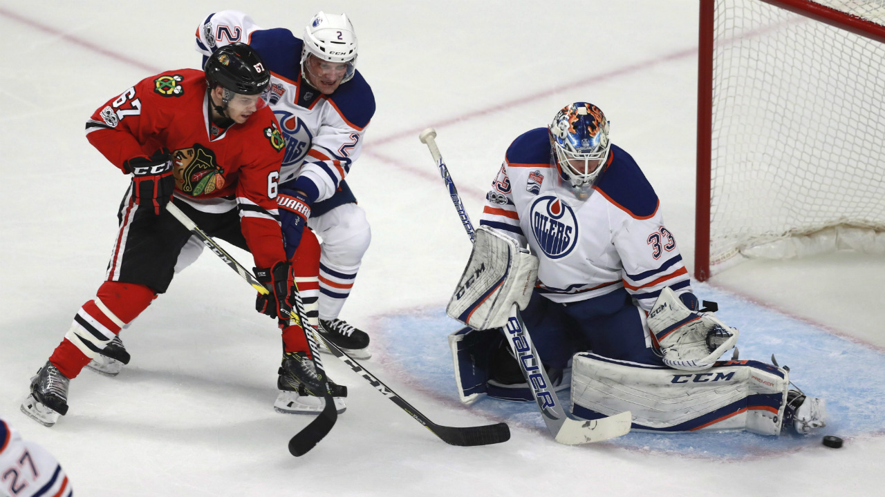 Edmonton-Oilers-goalie-Cam-Talbot-(33)-stops-a-shot-by-Chicago-Blackhawks-centre-Tanner-Kero-(67).-(Jeff-Hayes/AP)
