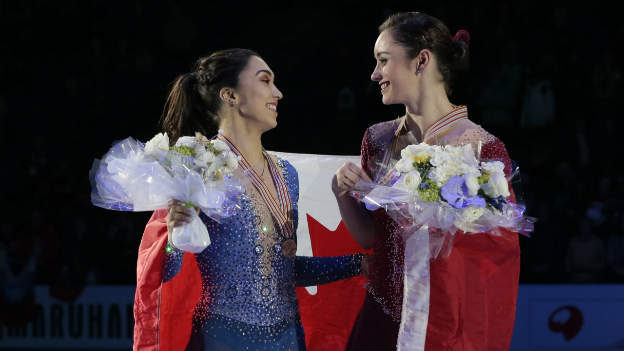 Kaetlyn-Osmond,-right,-and-Gabrielle-Daleman,-both-of-Canada,-smile-posing-with-their-silver-and-bronze-medals-and-the-national-flag-during-victory-ceremony-at-the-World-figure-skating-championships-in-Helsinki,-Finland,-on-Friday,-March-31,-2017.-(Ivan-Sekretarev/AP)