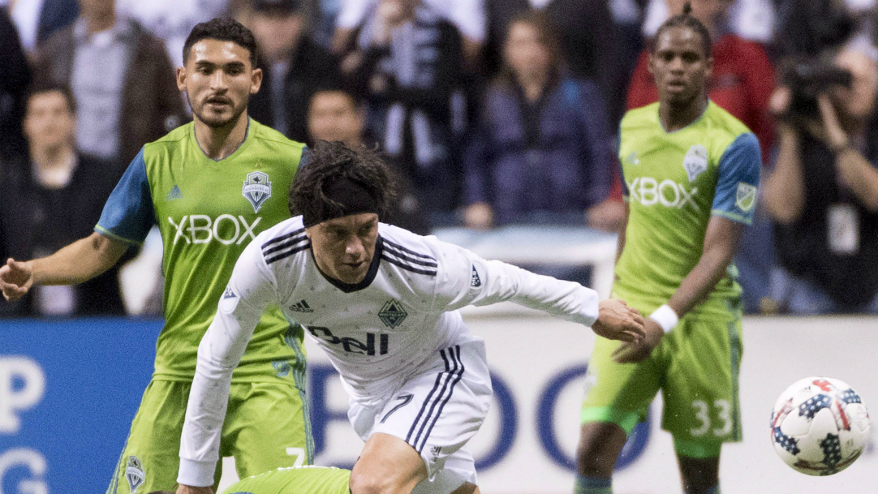 Vancouver-Whtiecaps'-Christian-Bolanos,-right,-fights-for-control-of-the-ball-with-Seattle-Sounders'-Harry-Shipp-during-the-first-half-of-MLS-soccer-action-in-Vancouver,-B.C.-Friday,-April-14,-2017.-(Jonathan-Hayward/CP)