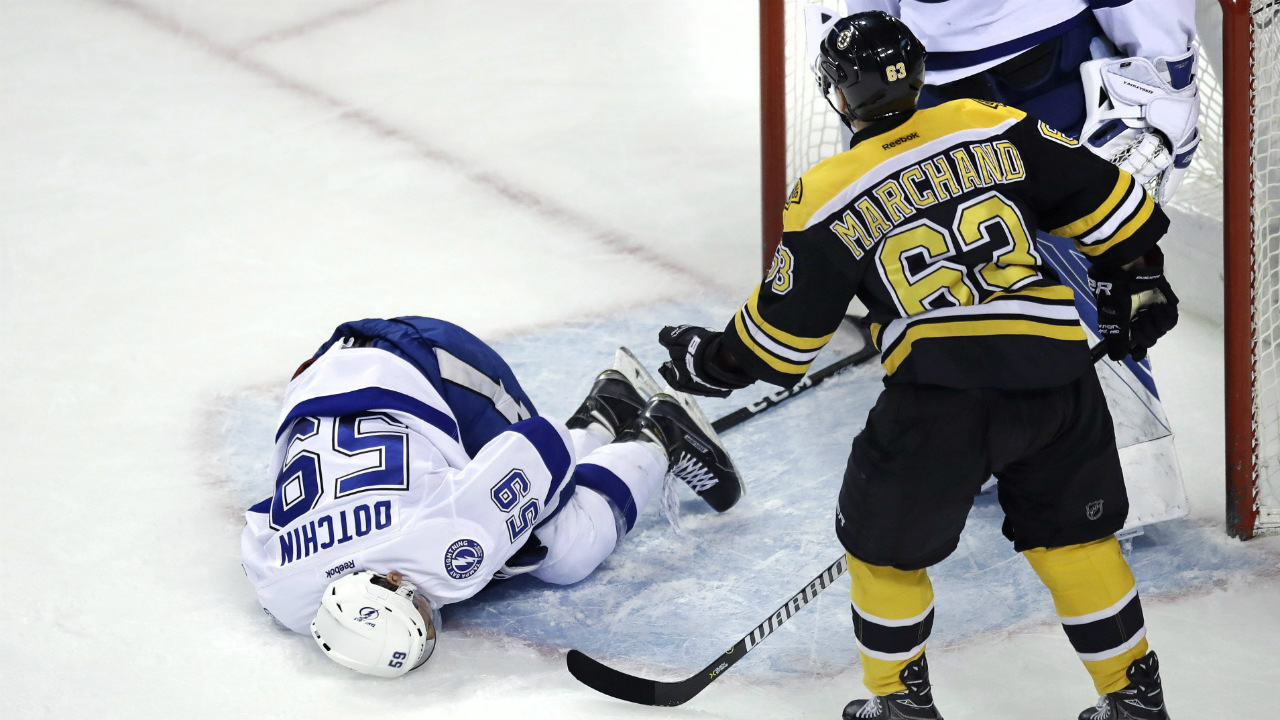 Tampa-Bay-Lightning-defenceman-Jake-Dotchin-(59)-lies-on-the-ice-after-an-altercation-with-Boston-Bruins-left-wing-Brad-Marchand-(63)-during-the-first-period-of-an-NHL-hockey-game-in-Boston,-Tuesday,-April-4,-2017.-Marchand-was-charged-with-spearing.-(Charles-Krupa/AP)