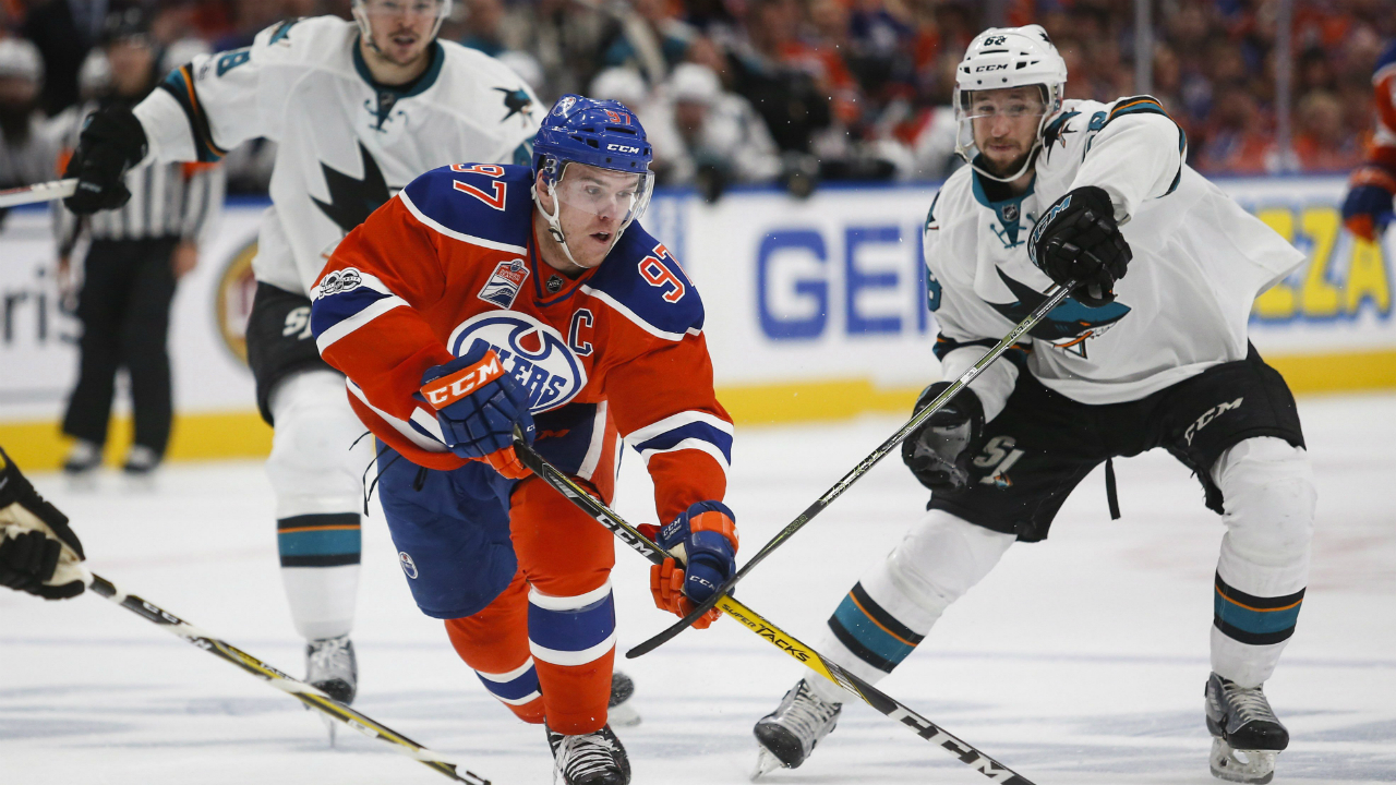 San-Jose-Sharks'-Melker-Karlsson,-right,-of-Sweden,-looks-on-as-Edmonton-Oilers'-Connor-McDavid-gets-away-from-him-during-overtime-NHL-hockey-round-one-playoff-action-in-Edmonton,-Thursday,-April-20,-2017.-(Jeff-McIntosh/CP)