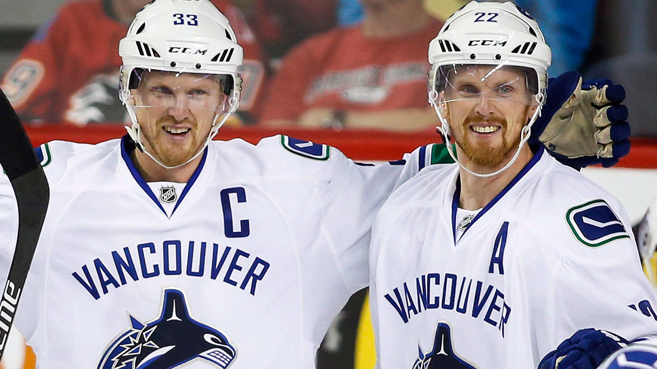 Vancouver-Canucks'-Henrik-Sedin,-left,-celebrates-with-his-brother-Daniel-Sedin.-(Jeff-McIntosh/CP)
