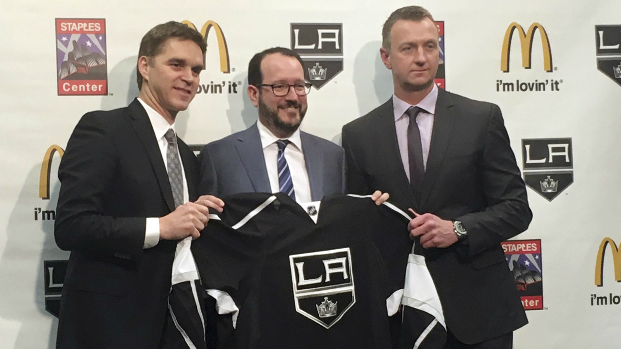 Los-Angeles-Kings-president-Luc-Robitaille,-left,-holds-up-a-team-jersey-with-Anschutz-Entertainment-Group-CEO-Dan-Beckerman,-middle,-and-Kings-general-manager-Rob-Blake-after-a-news-conference-Tuesday,-April-11,-2017,-in-Los-Angeles,-Calif.-Robitaille-and-Blake-were-promoted-by-the-Kings-after-the-firing-of-general-manager-Dean-Lombardi-and-coach-Darryl-Sutter.-(Greg-Beacham/AP)