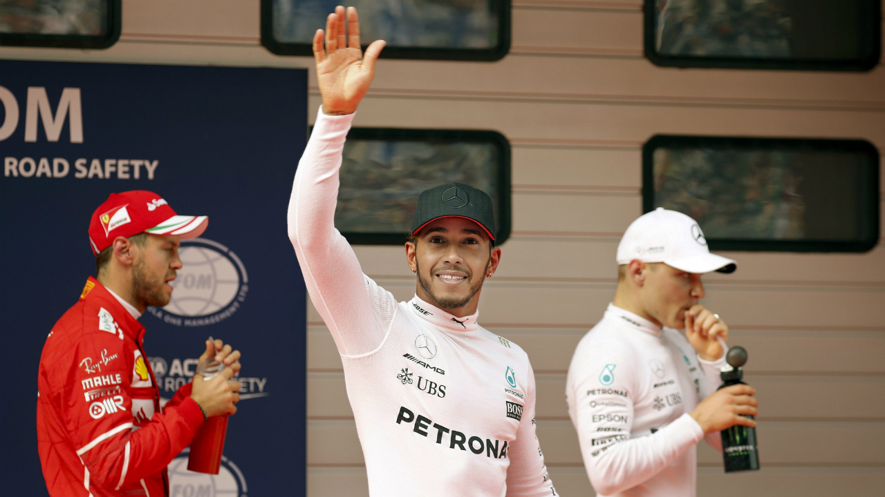 Mercedes-driver-Lewis-Hamilton-of-Britain,-center,-waves-next-to-his-teammate-Valtteri-Bottas-of-Finland,-right,-and-Ferrari-driver-Sebastian-Vettel-of-Germany-after-taking-pole-position-for-the-Chinese-Formula-One-Grand-Prix-at-the-Shanghai-International-Circuit-in-Shanghai,-China,-Saturday,-April-8,-2017.-Vettel-was-second-ahead-of-Bottas.-(Andy-Wong/AP)