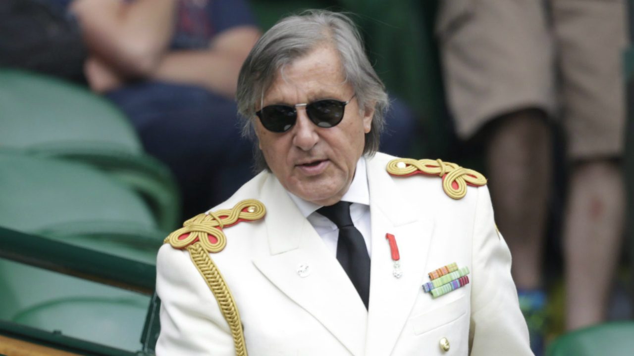 Former-tennis-player-Ilie-Nastase-takes-a-seat-on-Centre-Court,-prior-to-the-start-of-the-Serena-Williams-of-the-United-States-and-Venus-Williams-of-the-United-States,-at-the-All-England-Lawn-Tennis-Championships-in-Wimbledon,-London,-Monday-July-6,-2015.-(Alastair-Grant/AP)