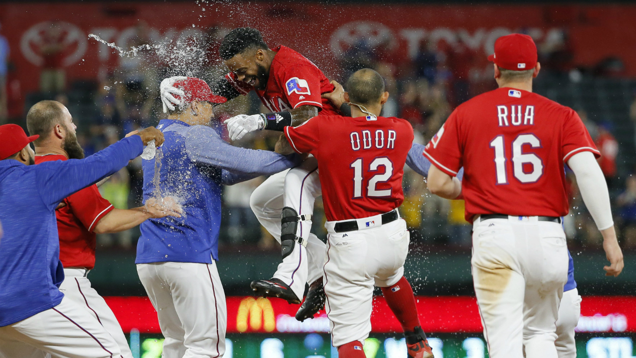 Texas-Rangers'-Delino-DeShields,-top,-celebrates-with-Rougned-Odor-(12),-Ryan-Rua-(16)-and-others-after-hitting-a-run-scoring-single-off-of-Kansas-City-Royals-reliever-Travis-Wood-during-the-13th-inning-of-a-baseball-game-in-Arlington,-Texas,-Thursday,-April-20,-2017.-The-hit-scored-Joey-Gallo-in-the-1-0-Rangers-win.-(Tony-Gutierrez/AP)