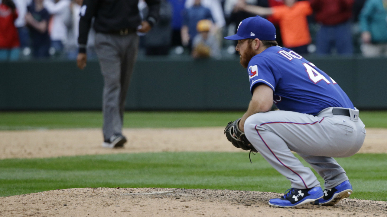 Texas-Rangers-closing-pitcher-Sam-Dyson-crouches-on-the-mound-after-he-gave-up-a-walk-off-RBI-single-to-Seattle-Mariners'-Nelson-Cruz-in-the-ninth-inning-of-a-baseball-game,-Sunday,-April-16,-2017,-in-Seattle.-The-Mariners-won,-8-7.-(Ted-S.-Warren/AP)