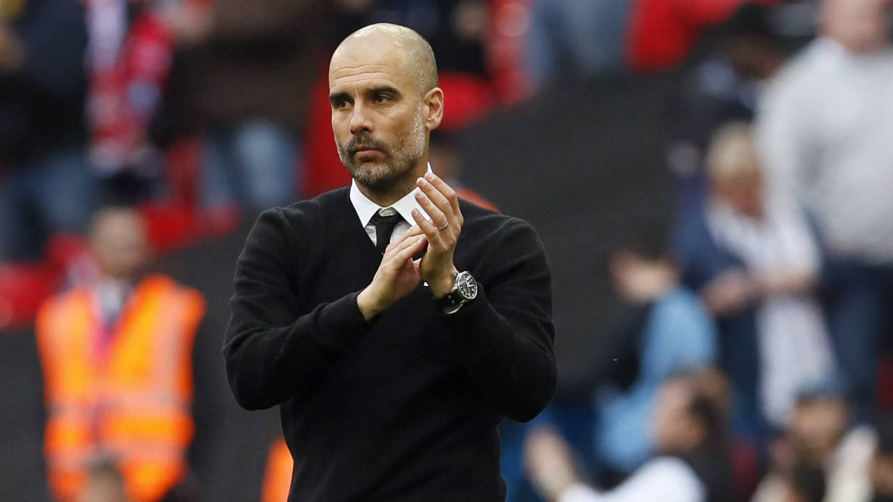Manchester-City-manager-Pep-Guardiola-applauds-at-the-end-of-the-English-FA-Cup-semifinal-soccer-match-between-Arsenal-and-Manchester-City-at-Wembley-stadium-in-London,-Sunday,-April-23,-2017.-Arsenal-won-2-1.-(Kirsty-Wigglesworth/AP)