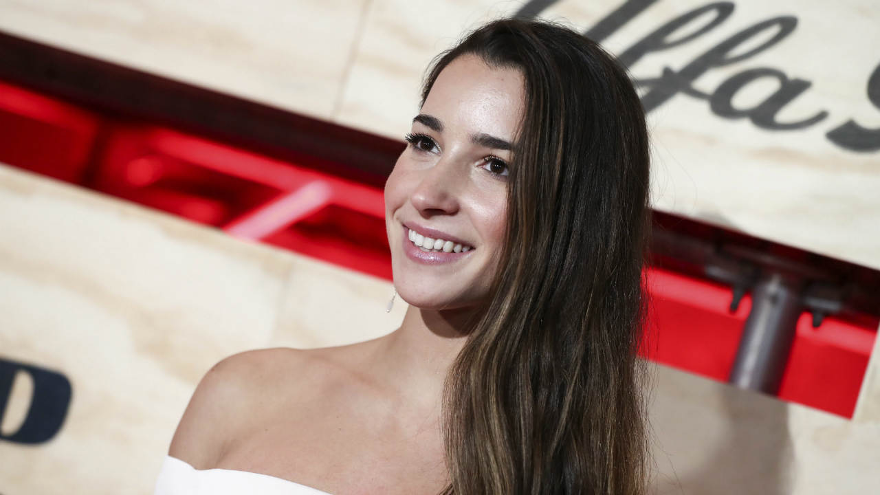 In-this-Feb.-3,-2017,-file-photo,-Aly-Raisman-attends-ESPN:-The-Party-2017-in-Houston,-Texas.-Raisman-used-Twitter-on-May-24,-2017,-to-call-out-an-airport-security-worker-who-she-says-questioned-whether-she-had-enough-muscles-to-be-a-gymnast.-(Photo-by-John-Salangsang/Invision/AP,-File)