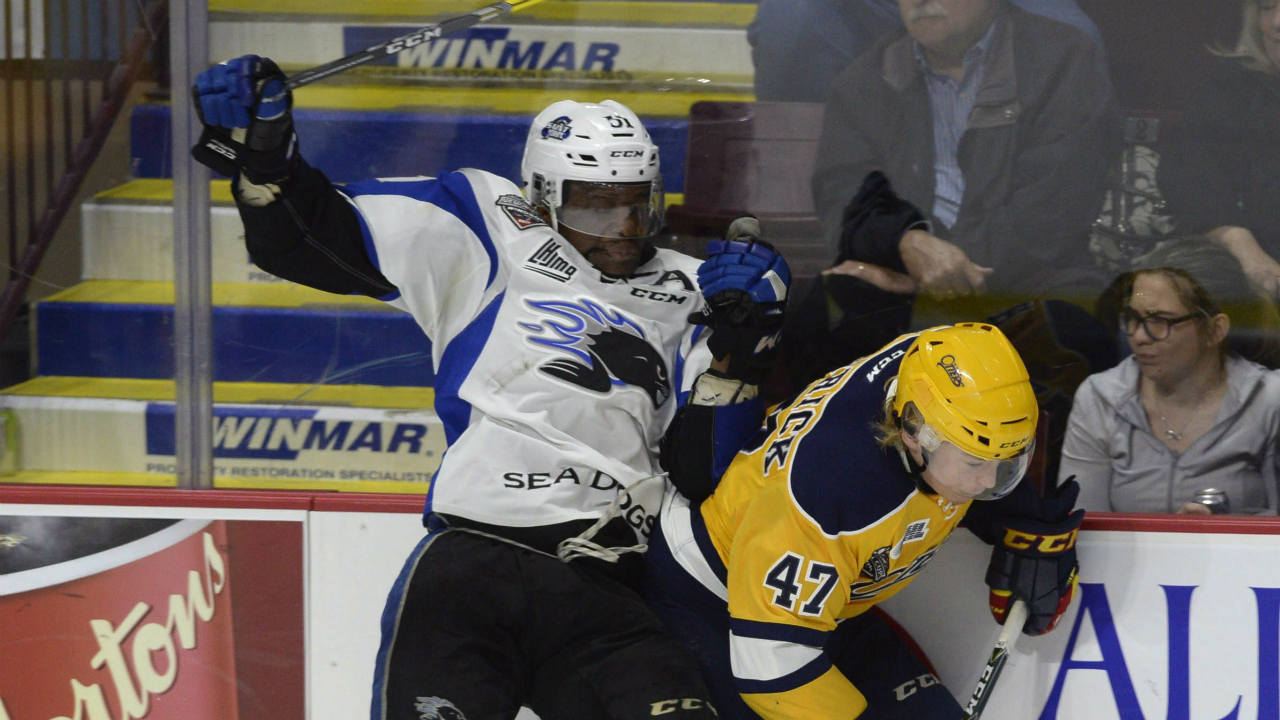 Erie-Otters-Owen-Headrick-(right)-and-Saint-John-Sea-Dogs-Bokondji-Imama-battle-for-the-puck-during-third-period-Memorial-Cup-semifinal-hockey-action-in-Windsor,-Ont.,-on-Friday,-May-26,-2017.-(Adrian-Wyld/CP)