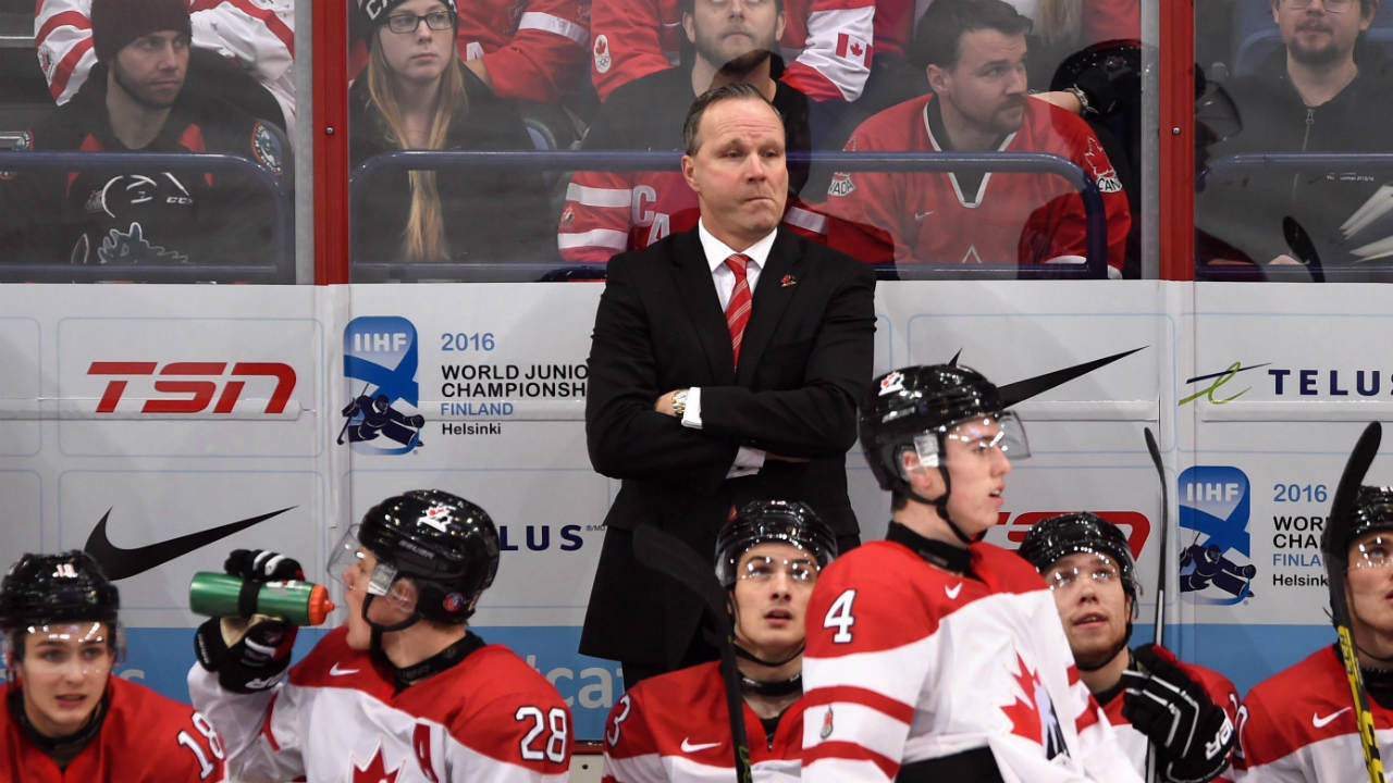 Canada's-coach-Dave-Lowry,-centre,-watches-from-the-bench-during-second-period-quarter-final-hockey-action-at-the-IIHF-World-Junior-Championship,-in-Helsinki,-Finland,-on-Saturday,-Jan.-2,-2016.-(Sean-Kilpatrick/CP)