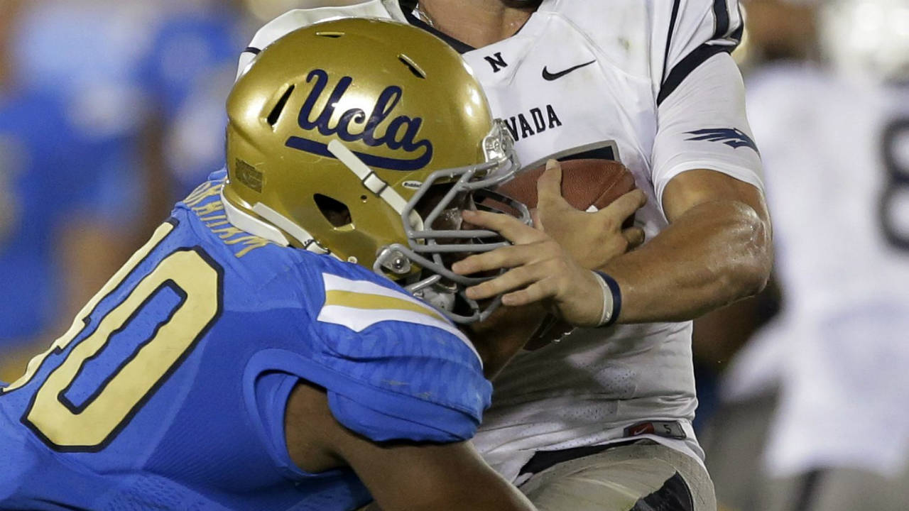 UCLA-cornerback-Fabian-Moreau,-left,-sacks-Nevada-quarterback-Cody-Fajardo-during-the-second-half-of-an-NCAA-college-football-game-in-Pasadena,-Calif.,-Saturday,-Aug.-31,-2013.-(Chris-Carlson/AP)
