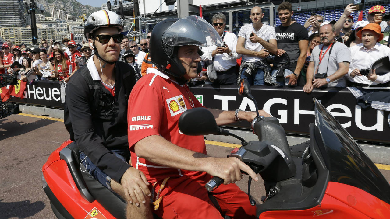 Ferrari-driver-Sebastian-Vettel,-left,-of-Germany-arrives-on-a-scooter-at-the-pit-lane-during-the-off-day-of-the-Formula-One-Grand-Prix-at-the-Monaco-racetrack-in-Monaco,-Friday,-May-26,-2017.-The-Formula-1-Grand-Prix-of-Monaco-will-take-place-on-Sunday-May-28.-(Claude-Paris/AP)