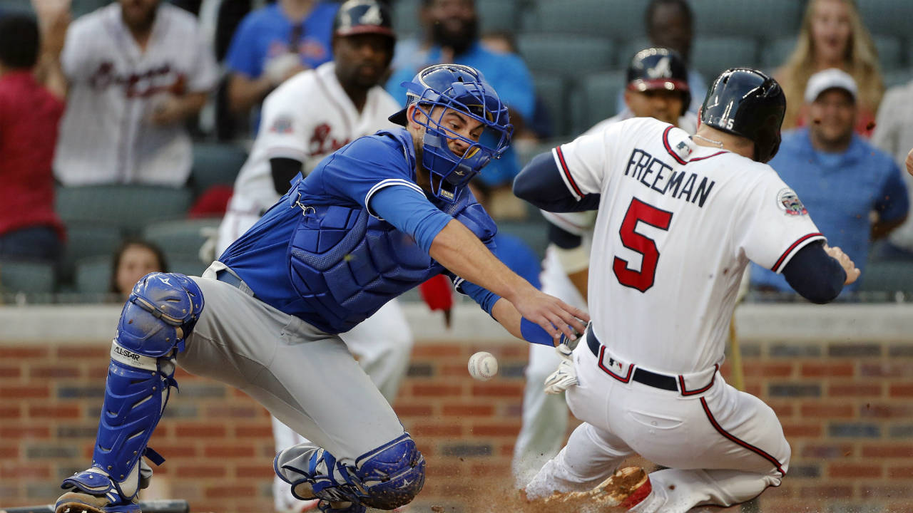 Atlanta-Braves'-Freddie-Freeman-(5)-scores-on-a-Nick-Markakis-two-run-base-hit-as-the-ball-gets-away-from-Toronto-Blue-Jays-catcher-Luke-Maile-(22)-in-the-first-inning-of-a-baseball-game,-Wednesday,-May-17,-2017,-in-Atlanta.-(John-Bazemore/AP)