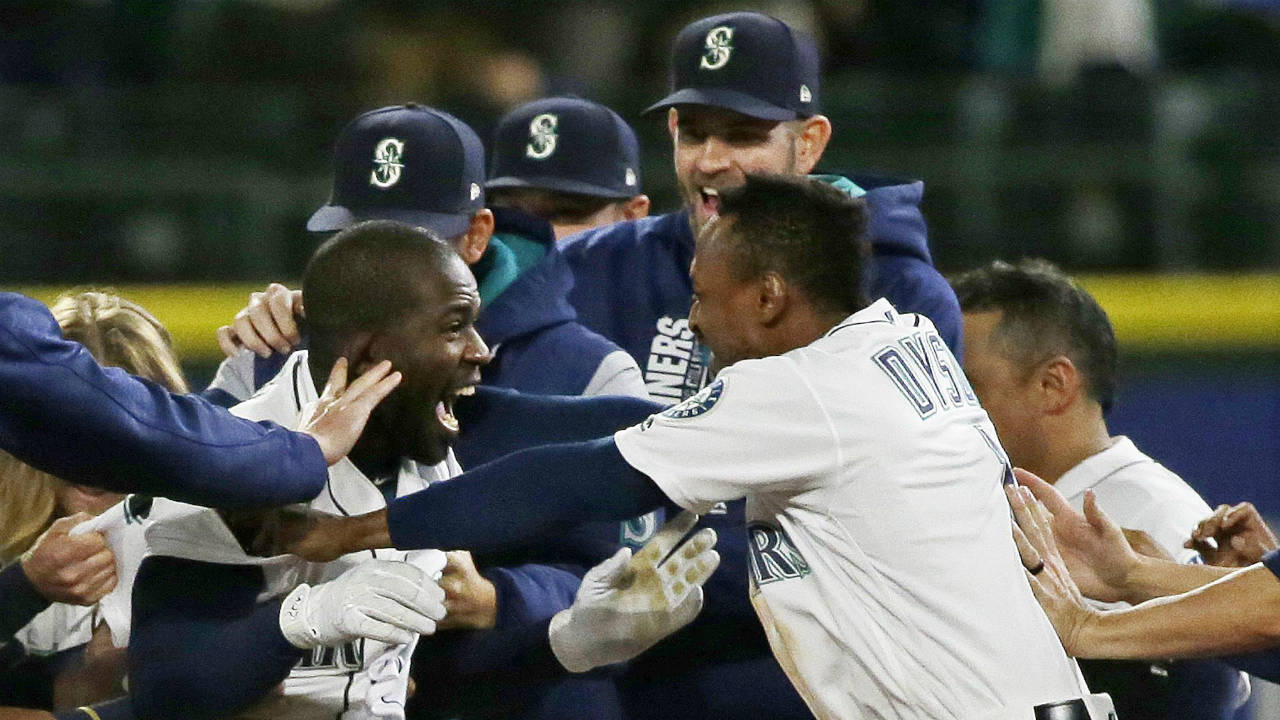 Seattle-Mariners'-Guillermo-Heredia,-left,-celebrates-with-Jarrod-Dyson,-right,-after-Herdia-hit-a-walk-off-RBI-to-score-Dyson-and-give-the-Mariners-a-5-4-win-over-the-Chicago-White-Sox-in-a-baseball-game,-Thursday,-May-18,-2017,-in-Seattle.-(Ted-S.-Warren/AP)