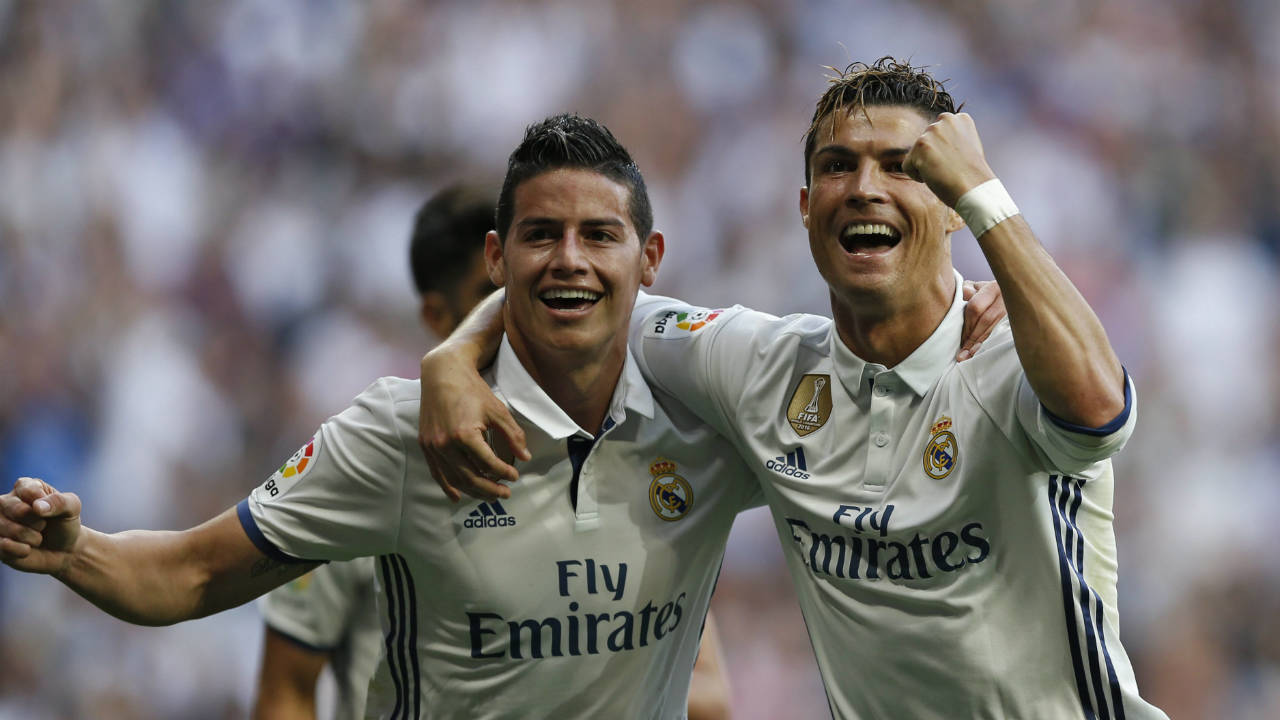 Real-Madrid's-Cristiano-Ronaldo,-right,-celebrates-with-teammate-James-Rodriguez-after-scoring-their-side's-second-goal-against-Sevilla-during-the-La-Liga-soccer-match-between-Real-Madrid-and-Sevilla-at-the-Santiago-Bernabeu-stadium-in-Madrid,-Sunday,-May-14,-2017.-Ronaldo-scored-twice-in-Real-Madrid's-4-1-victory.-(Francisco-Seco/AP)