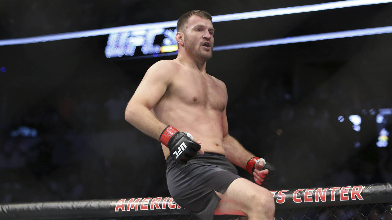 Stipe-Miocic,-celebrates-a-win-over-Junior-Dos-Santos-in-a-mixed-martial-arts-bout-at-UFC-211-for-the-UFC-heavyweight-championship,-Saturday,-May-13,-2017,-in-Dallas.-Miocic-retained-his-heavyweight-title.-(Gregory-Payan/AP)