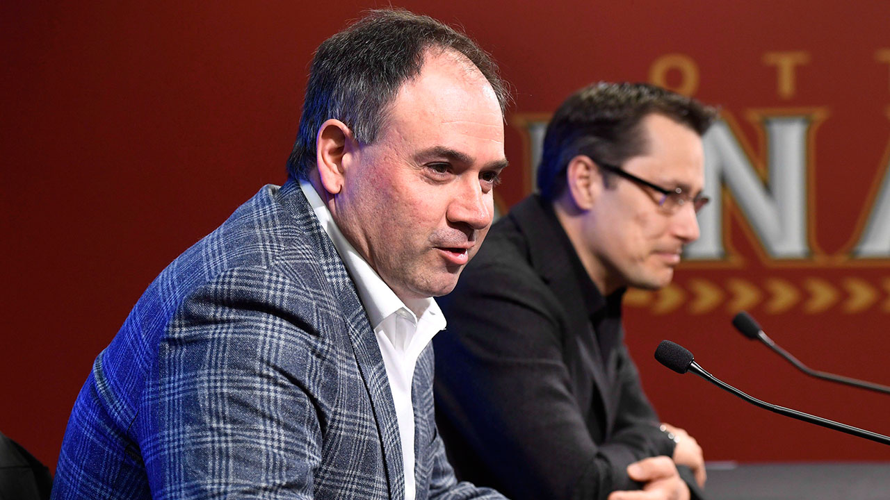 Ottawa-Senators-general-manager-Pierre-Dorion-answers-questions-from-media-in-June-2017-as-coach-Guy-Boucher-looks-on