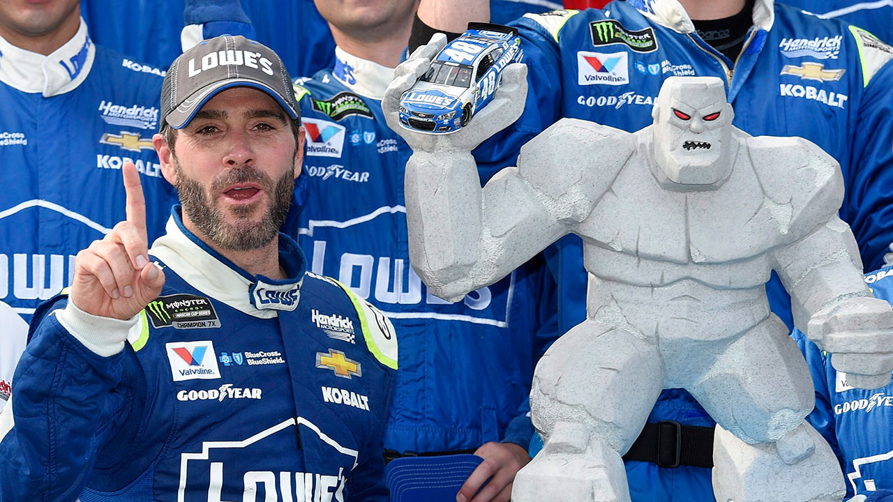 Jimmie-Johnson,-left,-poses-with-the-trophy-in-Victory-Lane-after-he-won-a-NASCAR-Cup-series-auto-race,-Sunday,-June-4,-2017,-at-Dover-International-Speedway-in-Dover,-Del.-[Nick-Wass/AP]