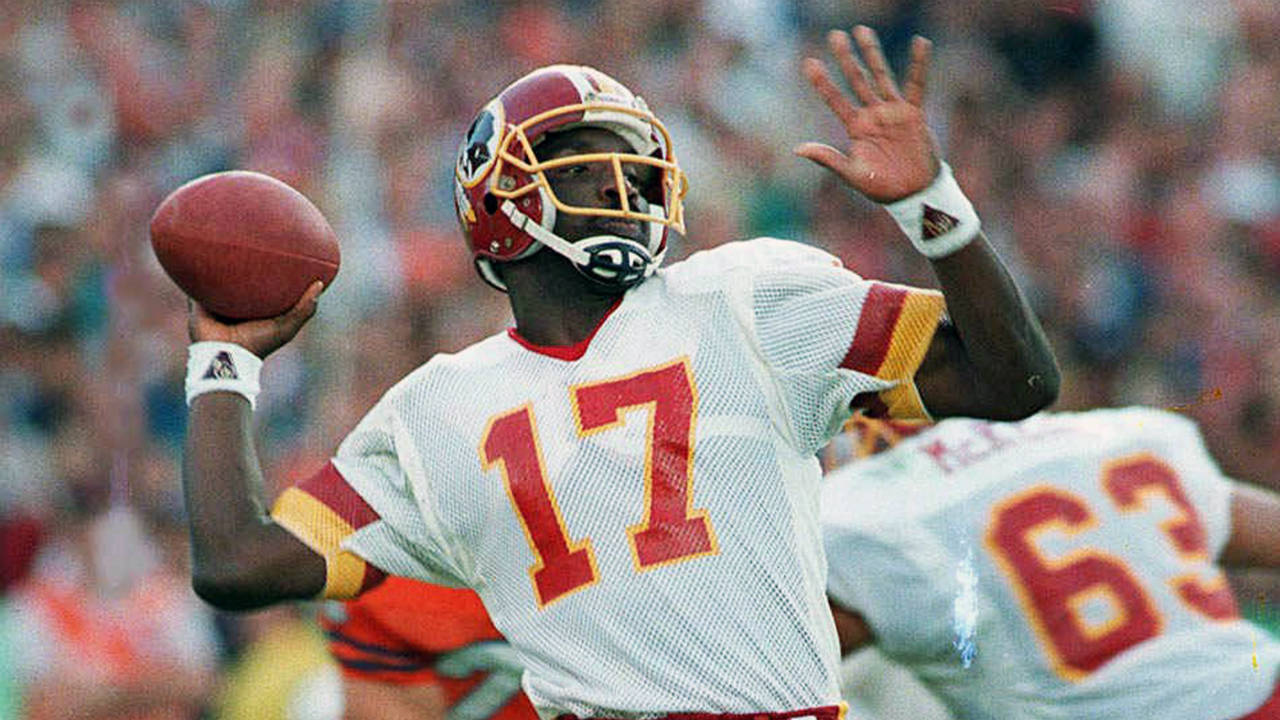 In-this-Jan.-31,-1988,-file-photo,-Washington-Redskins-quarterback-Doug-Williams-prepares-to-let-go-of-a-pass-during-first-quarter-of-Super-Bowl-XXII-against-the-Denver-Broncos-in-San-Diego.-Williams,-who-set-a-record-with-340-yards-passing-in-the-NFL-football-game-and-became-the-first-African-American-quarterback-to-win-a-Super-Bowl.-(Elise-Amendola,-File/AP)