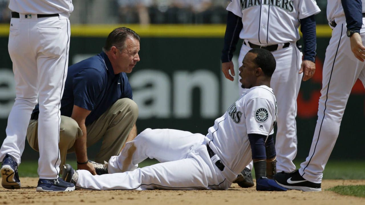 Seattle-Mariners'-Jean-Segura,-bottom,-is-examined-by-trainer-Rob-Nodine-after-suffering-an-injury-sliding-into-second-base-in-the-fourth-inning-of-a-baseball-game-against-the-Colorado-Rockies,-Thursday,-June-1,-2017,-in-Seattle.-Segura-was-out-on-the-play-and-left-the-game.-(Ted-S.-Warren/AP)
