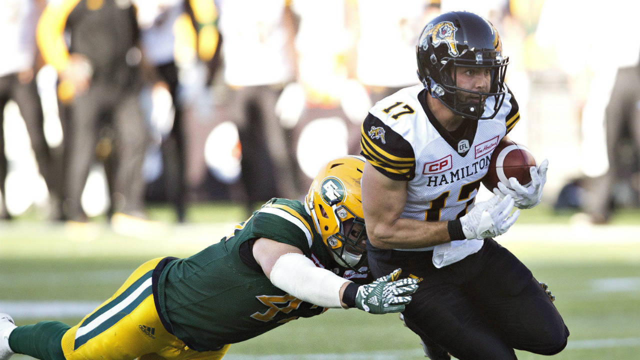 Hamilton-Tiger-Cats'-Luke-Tasker-(17)-is-tackled-by-Edmonton-Eskimos'-Tyler-Thornton-(42)-during-second-half-CFL-action-in-Edmonton,-Alta.,-on-Saturday-July-23,-2016.-(Jason-Franson/CP)