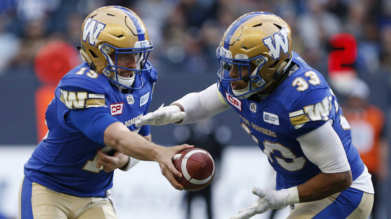Winnipeg-Blue-Bombers-quarterback-Matt-Nichols-(15)-hands-off-to-Andrew-Harris-(33)-during-the-first-half-of-CFL-action-against-the-Edmonton-Eskimos,-in-Winnipeg-on-Thursday,-June-15,-2017.-(John-Woods/CP)