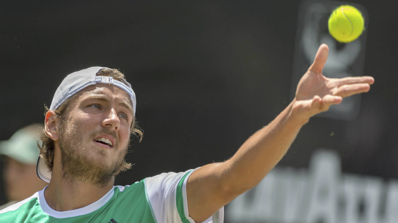 Lucas-Pouille-of-France-serves-to-Germany's-Philipp-Kohlschreiber-during-their-quarterfinal-match-at-the-Mercedes-Cup-tennis-tournament-in-Stuttgart,-Germany-Friday,-June-16,-2017.-(Daniel-Maurer/dpa-via-AP)