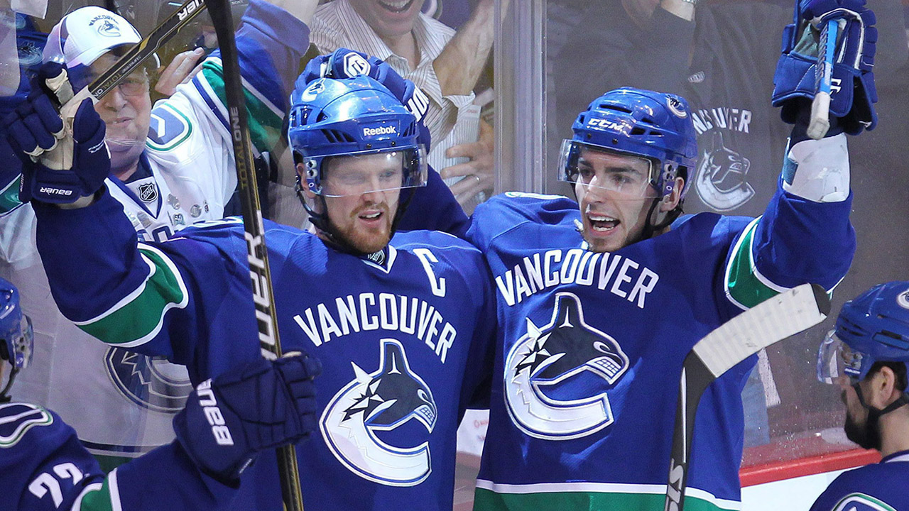 Vancouver-Canucks'-Alex-Burrows,-right,-celebrates-his-goal-with-teammate-Henrik-Sedin.-(Jonathan-Hayward/CP)