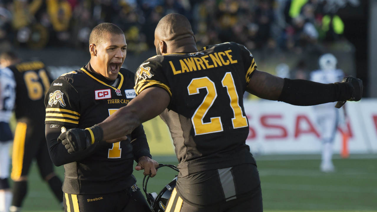 Hamilton-Tiger-Cats'-p/k-Justin-Medlock-(7)-reacts-with-teammate-Simoni-Lawrence-(21).-(Nathan-Denette/CP)
