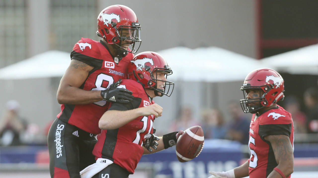 Calgary-Stampeders'-Andrew-Buckley,-centre,-celebrates-his-touchdown-with-teammates-Kamar-Jorden,-left,-and-Marquay-McDaniel-(16)-in-second-half-CFL-action-against-the-Ottawa-Redblacks,-in-Calgary,-Thursday,-June-29,-2017.-Calgary-defeated-Ottawa-43---39.-(Mike-Ridewood/CP)