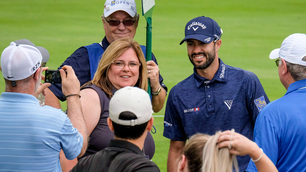 Adam-Hadwin,-of-Abbotsford-B.C.,-poses-for-pictures-with-fan.-(David-Cooper/CP)