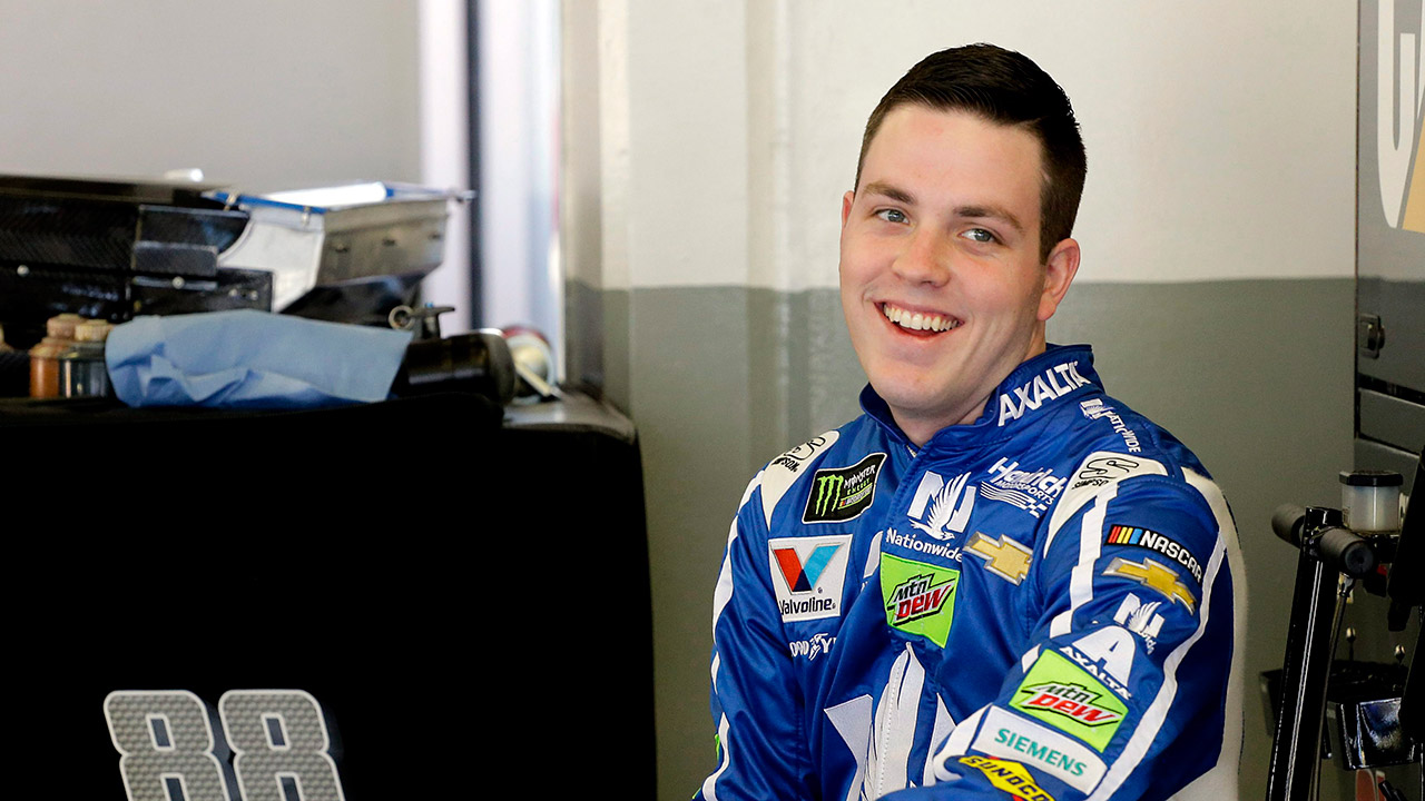 Alex-Bowman-smiles-to-team-members-in-his-garage-during-a-practice-session.-(Terry-Renna/AP)