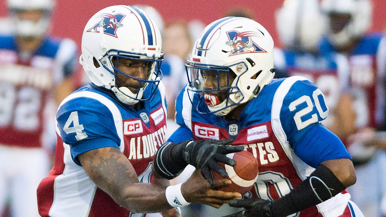 Montreal-Alouettes-quarterback-Darian-Durant-(4)-hands-off-to-Tyrell-Sutton.-(Graham-Hughes/AP)