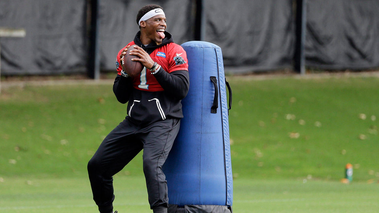 Carolina-Panthers'-Cam-Newton-smiles-as-he-runs-a-drill.-(Chuck-Burton/AP)