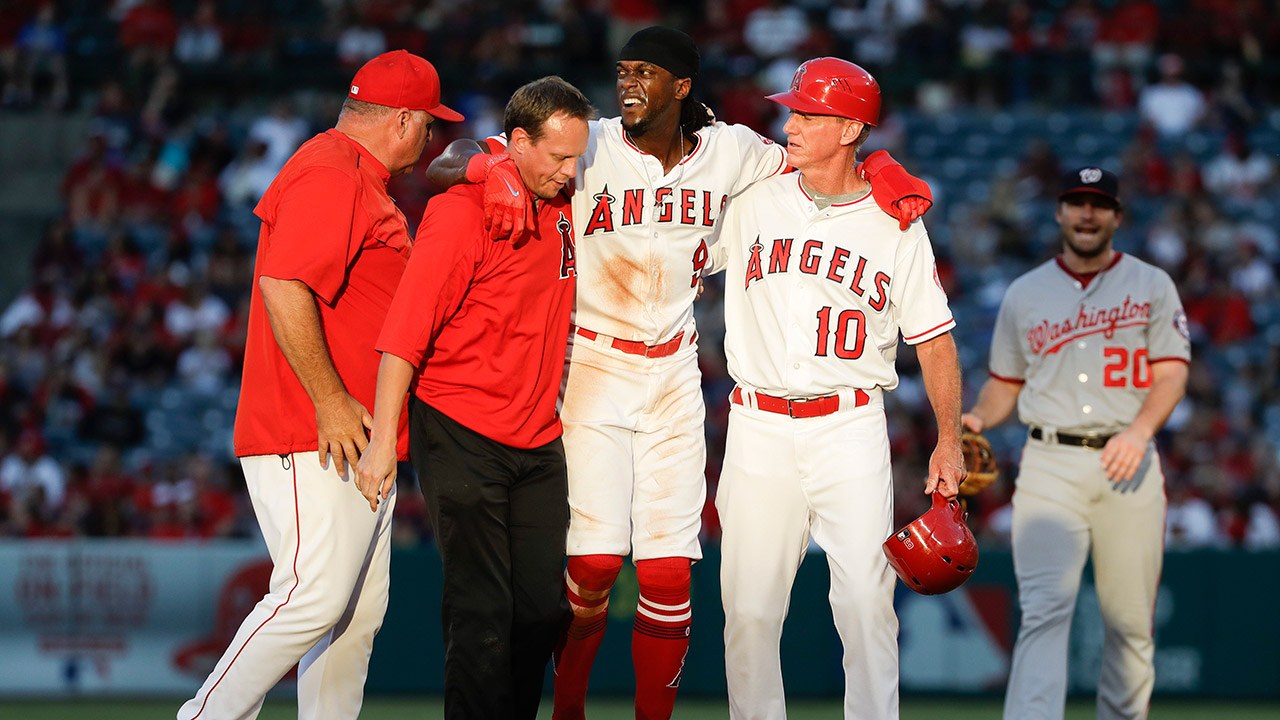 Los-Angeles-Angels'-Cameron-Maybin,-center,-is-helped-off-the-field.-(Chris-Carlson/AP)