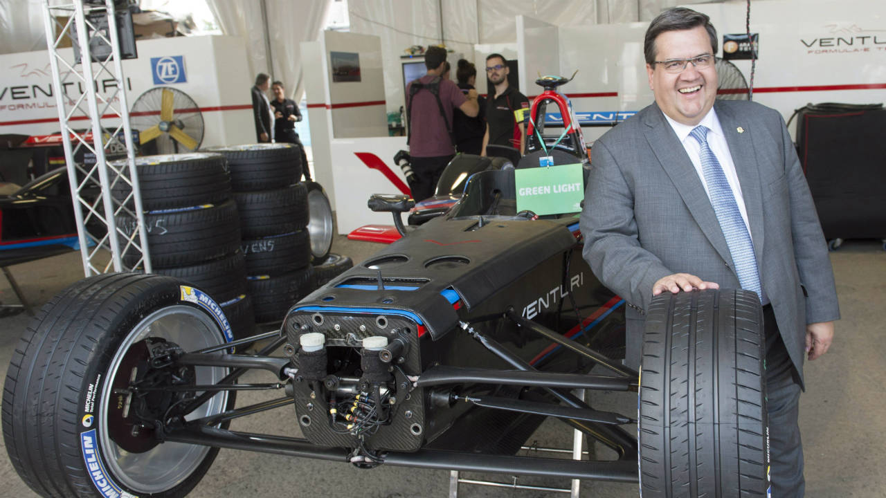 Montreal-Mayor-Denis-Coderre-poses-for-a-photo-beside-a-vehicle-as-he-visits-the-Team-Venturi-garage-at-the-Montreal-Formula-ePrix-electric-car-race,-in-Montreal-on-Friday,-July-28,-2017.-(Ryan-Remiorz/CP)