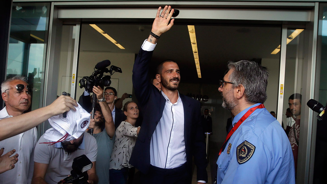 Italy-defender-Leonardo-Bonucci-waves-to-fans-as-he-walks-off-AC-Milan's-headquarters.-(Luca-Bruno/AP)
