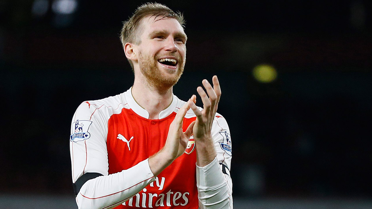 FILE---This-is-a-Monday,-Dec.-28,-2015-file-photo-of-Arsenal's-captain-Per-Mertesacker-as-he-claps-to-the-fans-at-the-end-of-the-English-Premier-League-soccer-match-between-Arsenal-and-Bournemouth-at-Emirates-stadium-in-London.-Arsenal-defender-Per-Mertesacker-will-play-one-last-season-at-the-Premier-League-club-before-retiring-to-become-its-academy-manager.-The-32-year-old-center-back-joined-Arsenal-in-2011.-(Kirsty-Wigglesworth/AP)