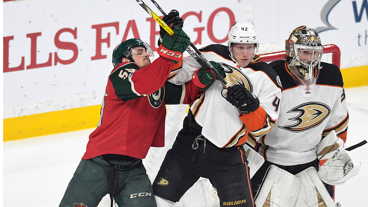 Anaheim-Ducks'-Cam-Fowler,-center,-pushes-Minnesota-Wild's-Zack-Mitchell,-left,-away-from-Ducks'-goal-John-Gibson,-right-in-the-first-period-of-an-NHL-hockey-game,-Tuesday,-Feb.-14,-2017,-in-St.-Paul,-Minn.-(Tom-Olmscheid/AP)