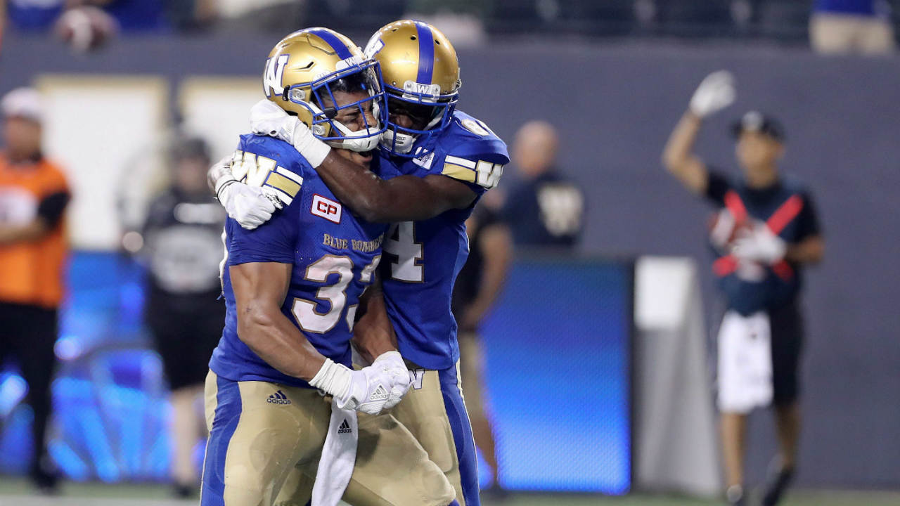 Winnipeg-Blue-Bombers-running-back-Andrew-Harris-(33)-and-wide-receiver-Ryan-Lankford-(84)-celebrate-after-Harris-scored-the-winning-touchdown-against-the-Montreal-Alouettes-during-the-second-half-of-CFL-football-action-in-Winnipeg-on-Thursday,-July-27,-2017.-(Trevor-Hagan/CP)