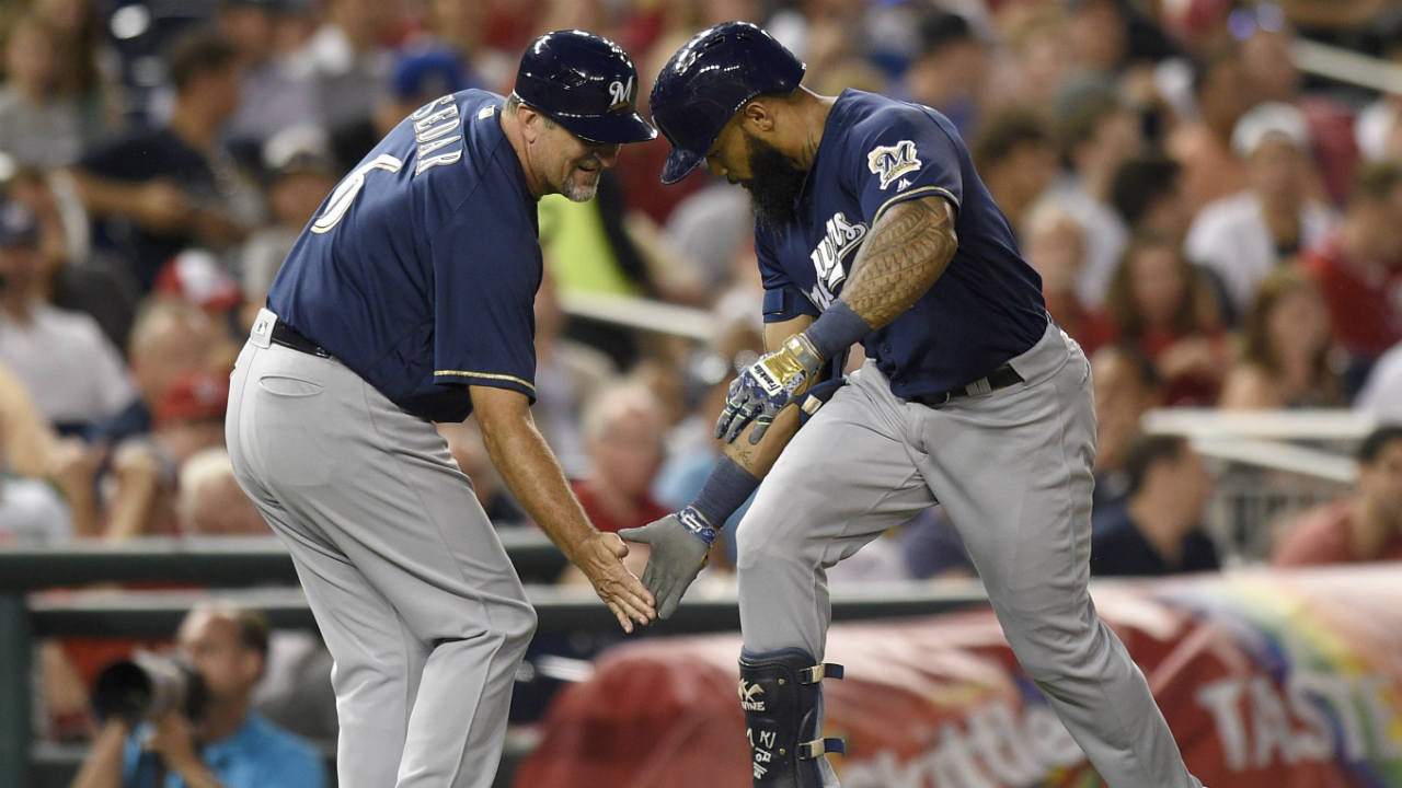 Milwaukee-Brewers'-Eric-Thames,-right,-is-greeted-by-third-base-coach-Ed-Sedar-(6)-as-he-rounds-the-bases-after-his-home-run-during-the-fifth-inning-of-a-baseball-game-against-the-Washington-Nationals,-Tuesday,-July-25,-2017,-in-Washington.-(Nick-Wass/AP)