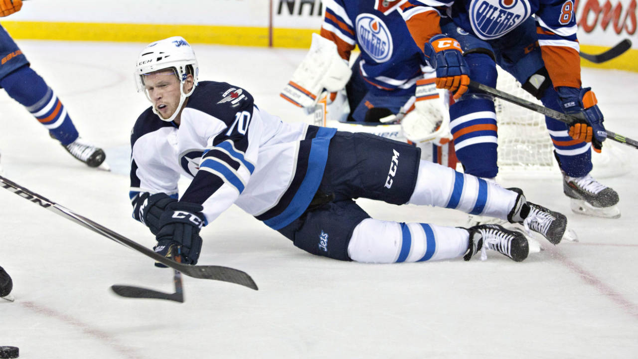 Winnipeg-Jets-John-Albert-(70)-is-knocked-down-by-Edmonton-Oilers-David-Musil-(87)-during-first-period-NHL-hockey-action-in-Edmonton,-on-Monday-September-29,-2014.-(Jason-Franson/CP)