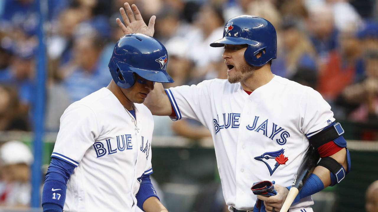 Toronto-Blue-Jays'-Josh-Donaldson,-right,-congratulates-teammate-Ryan-Goins-after-scoring-during-second-inning-American-League-MLB-baseball-action-in-Toronto-on-Tuesday,-July-25,-2017.-(Mark-Blinch/CP)