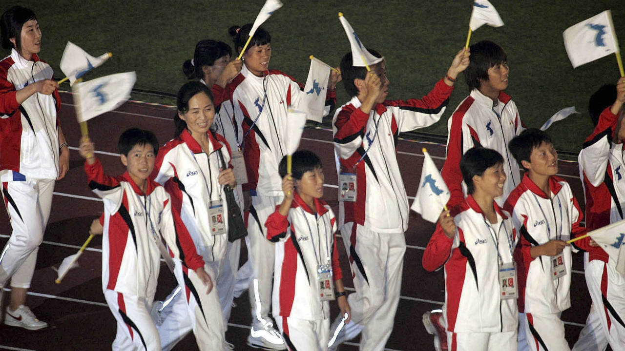 In-this-Aug.-31,-2005-file-photo,-North-and-South-Korean-athletes-mingle-as-they-march-together-during-the-opening-ceremony-of-the-16th-Asian-Athletics-Championships-2005-in-Incheon,-South-Korea.-Sports-ties-between-the-rival-Koreas-often-mirror-their-rocky-political-ties.-(Lee-Jin-man,-File/AP)