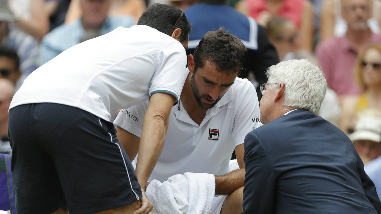 Croatia's-Marin-Cilic-receives-treatment-during-a-change-of-ends-break-as-he-plays-Switzerland's-Roger-Federer-in-the-Men's-Singles-final-match-on-day-thirteen-at-the-Wimbledon-Tennis-Championships-in-London-Sunday,-July-16,-2017.-(Alastair-Grant/AP)