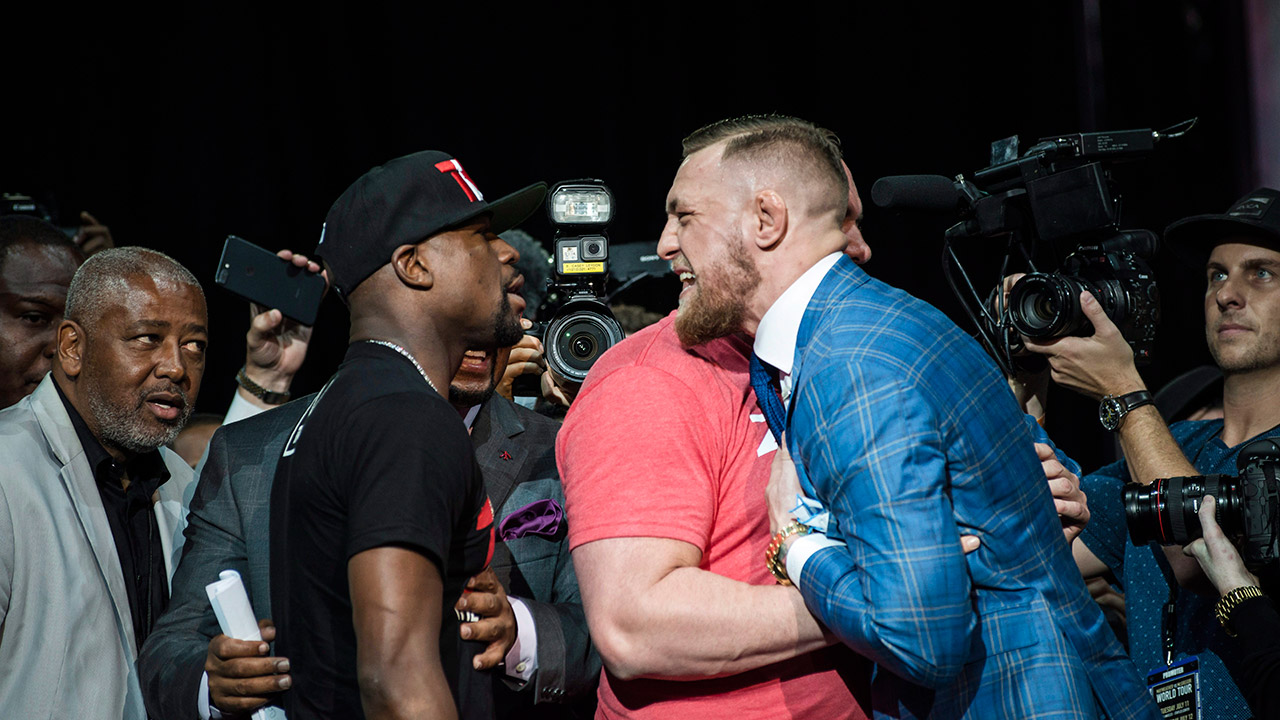 Floyd-Mayweather,-left,-and-Conor-McGregor-exchange-harsh-words-during-a-promotional-tour-stop-in-Toronto-.-(Christopher-Katsarov/AP)